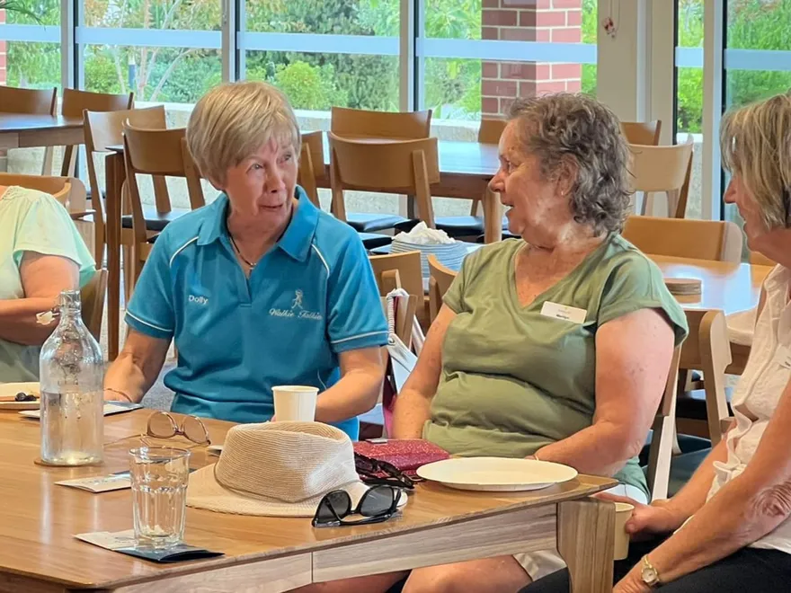 Clients and support workers sitting together around a table