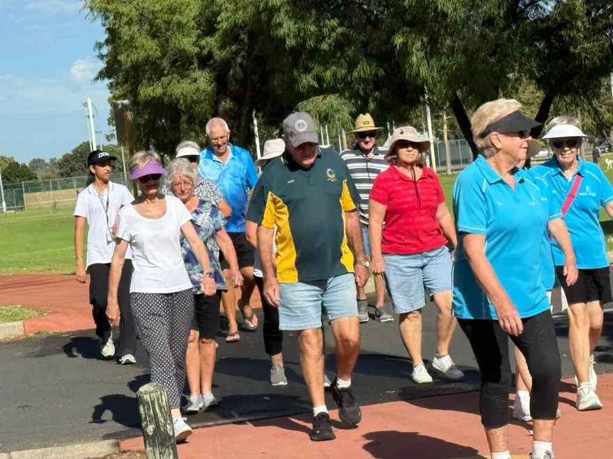 A group walking together outdoors in Sewa Care shirts